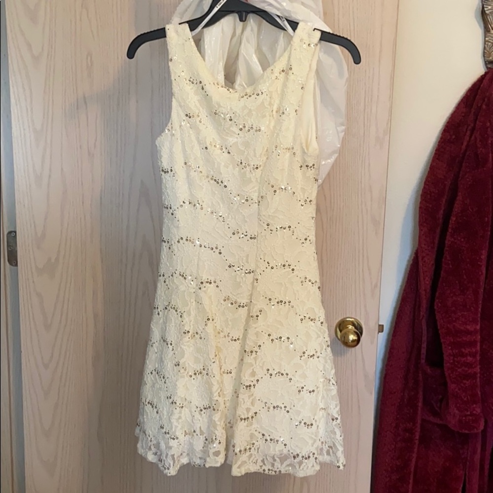 White short flowey dress, with sequins and lace.